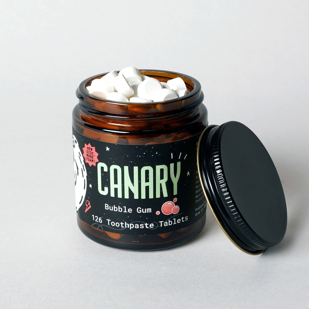 Canary Clean Co toothpaste tablets in a glass jar with a metal lid